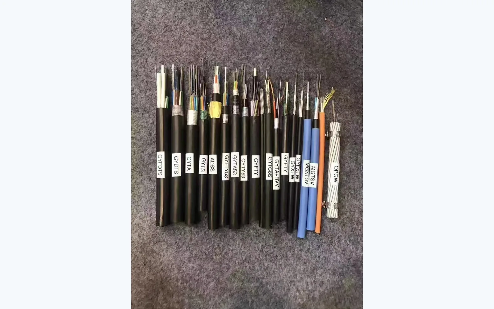 Factory cable construction samples including loose-tube designs, used as a product-family reference rather than a ribbon sample or an installed African backbone