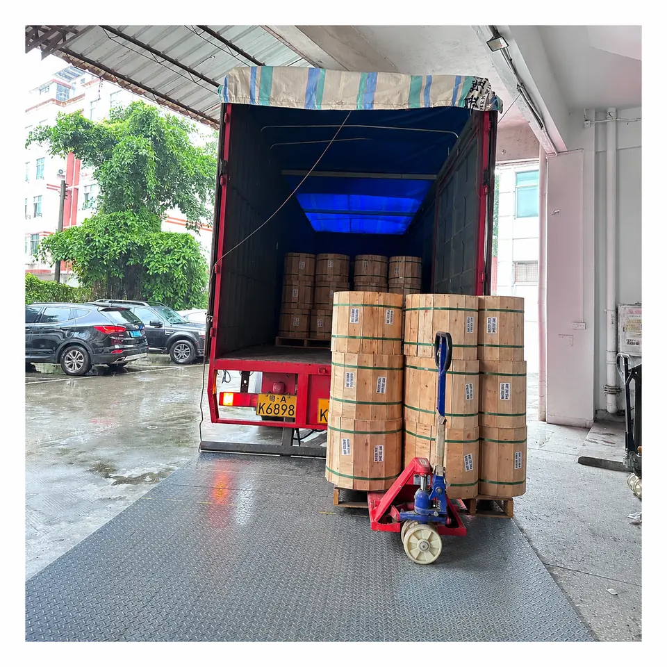 Wooden cable drums being loaded for export shipment